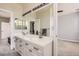 Well-lit primary bathroom featuring a double sink vanity, and a large mirror at 7866 Witney Pl, Lone Tree, CO 80124