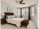 Comfortable bedroom with neutral tones, plush carpet, ceiling fan, and a large window letting in natural light at 7866 Witney Pl, Lone Tree, CO 80124