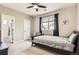 Comfortable bedroom featuring a window, bed, closet, and door to the ensuite bathroom at 7866 Witney Pl, Lone Tree, CO 80124