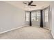 Spacious carpeted bedroom featuring natural light from windows and a ceiling fan at 7866 Witney Pl, Lone Tree, CO 80124