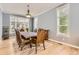 Traditional dining room with hardwood floors, a large window, and a classic chandelier at 7866 Witney Pl, Lone Tree, CO 80124