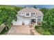 Beautiful two-story home featuring a three-car garage, well-manicured lawn and a covered entryway at 7866 Witney Pl, Lone Tree, CO 80124