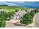 Stunning home with a lush green lawn, mature trees, and a charming covered front porch at 7866 Witney Pl, Lone Tree, CO 80124