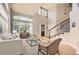 Spacious foyer with large windows, high ceilings, and an elegant staircase leading to the upper level at 7866 Witney Pl, Lone Tree, CO 80124