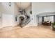 Grand foyer featuring a curved staircase, hardwood floors, and high ceilings with elegant lighting at 7866 Witney Pl, Lone Tree, CO 80124