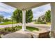 Inviting covered porch with a classic column, colorful flowers, and a tranquil neighborhood view at 7866 Witney Pl, Lone Tree, CO 80124