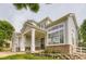 Close up showing a welcoming covered porch with classic columns and well-maintained landscaping at 7866 Witney Pl, Lone Tree, CO 80124