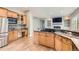 Open concept kitchen features granite counters, stainless appliances, island cooktop, and seamless flow to the living area at 7866 Witney Pl, Lone Tree, CO 80124