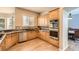 Well-appointed kitchen featuring stainless steel appliances, tile backsplash, wood floors and a large window over the sink at 7866 Witney Pl, Lone Tree, CO 80124