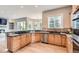 Gourmet kitchen features granite countertops, stainless steel appliances, wood floors and seamless access to the living area at 7866 Witney Pl, Lone Tree, CO 80124