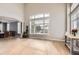 Open-concept living room featuring lots of natural light, hardwood floors, and neutral paint at 7866 Witney Pl, Lone Tree, CO 80124