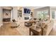 Bright living room featuring a modern fireplace with stone surround, hardwood floors, and ample seating at 7866 Witney Pl, Lone Tree, CO 80124