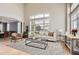 Inviting living room with high ceilings, large windows, and seamless flow into the adjacent dining area at 7866 Witney Pl, Lone Tree, CO 80124