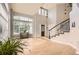Bright living room with hardwood floors, soaring ceilings, large windows and staircase at 7866 Witney Pl, Lone Tree, CO 80124