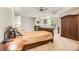 Inviting main bedroom with fireplace, large windows, and a ceiling fan, offering a comfortable and bright atmosphere at 7866 Witney Pl, Lone Tree, CO 80124