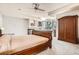 Large main bedroom with fireplace, hardwood armoire, bay windows and neutral carpet at 7866 Witney Pl, Lone Tree, CO 80124