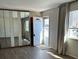 Living room with a large mirrored closet, window, and hardwood floors at 7331 Utica St, Westminster, CO 80030