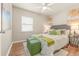 Bedroom with a queen bed and green accents at 1250 S Tennyson St, Denver, CO 80219