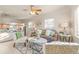 Cozy living room showcasing a decorative ceiling fan and an open layout to the adjacent kitchen at 1250 S Tennyson St, Denver, CO 80219