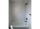 Stylish tiled bathtub with a shower combination and sleek fixtures in a modern bathroom at 14223 Currant St, Broomfield, CO 80020