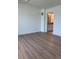 Bedroom featuring hardwood floors with a view into the ensuite bathroom at 14223 Currant St, Broomfield, CO 80020