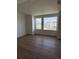Bright bedroom with hardwood floors and large windows offering neighborhood views at 14223 Currant St, Broomfield, CO 80020
