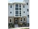 Charming townhome featuring a modern exterior design with large windows and landscaped front yard at 14223 Currant St, Broomfield, CO 80020