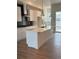 Beautiful kitchen featuring a large center island, modern light fixtures, and stainless steel appliances at 14223 Currant St, Broomfield, CO 80020
