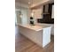 Modern kitchen showcasing a large island, stainless appliances, stylish lighting, and a gas cooktop at 14223 Currant St, Broomfield, CO 80020