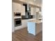 Beautiful kitchen featuring stainless steel appliances, white cabinets, and a spacious center island at 14223 Currant St, Broomfield, CO 80020