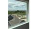 Breathtaking window view showcases scenic mountains, mature trees, and a glimpse of the neighborhood at 14223 Currant St, Broomfield, CO 80020