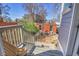 Outdoor stairs leading down to a spacious backyard with a brick patio and lush greenery at 161 S Pearl St, Denver, CO 80209
