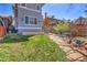 Backyard featuring a patio with table and chairs and lush greenery at 161 S Pearl St, Denver, CO 80209