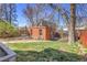 Backyard featuring a brick patio with table and chairs and lush greenery at 161 S Pearl St, Denver, CO 80209