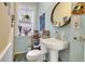 Charming powder room featuring a pedestal sink, natural light, and lovely decor at 161 S Pearl St, Denver, CO 80209
