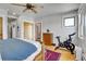 Bright bedroom featuring natural wood floors, a ceiling fan, and sliding glass door access to the outside at 161 S Pearl St, Denver, CO 80209
