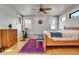 Inviting bedroom with hardwood floors, a ceiling fan, and an exercise bike at 161 S Pearl St, Denver, CO 80209
