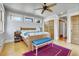Bedroom with hardwood floors, ceiling fan, a bedside table and a blue bench at the foot of the bed at 161 S Pearl St, Denver, CO 80209