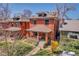 Charming two-story brick home features a cozy front porch, lush landscaping and mature trees for added curb appeal at 161 S Pearl St, Denver, CO 80209