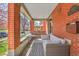 Charming brick front porch with a swing, comfortable seating and stylish decor at 161 S Pearl St, Denver, CO 80209