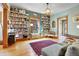Inviting living room with built-in bookshelves, warm lighting, and wood floors at 161 S Pearl St, Denver, CO 80209
