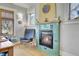 Comfortable living room showcasing a turquoise tiled fireplace with wood floors and light filled windows at 161 S Pearl St, Denver, CO 80209