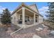Inviting covered patio with a built-in grill and comfortable seating area, perfect for outdoor entertaining at 8440 Rush Creek Ave, Littleton, CO 80125