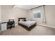 Cozy bedroom featuring a bed, desk, and natural light from a window at 8440 Rush Creek Ave, Littleton, CO 80125