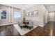 Well-lit dining area with modern chandelier, hardwood floors, and neutral decor at 8440 Rush Creek Ave, Littleton, CO 80125