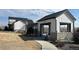Modern home exterior featuring a stone facade, stylish architectural details, and professional landscaping at 8440 Rush Creek Ave, Littleton, CO 80125