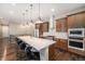 Modern kitchen with a large center island, stainless steel appliances, and stylish pendant lighting at 8440 Rush Creek Ave, Littleton, CO 80125