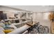 Relaxing living room with an oversized sectional, multiple tables, and stylish carpet at 8440 Rush Creek Ave, Littleton, CO 80125