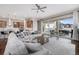 Open concept living space with sleek floors, oversized sliding glass doors, and modern kitchen at 8440 Rush Creek Ave, Littleton, CO 80125