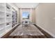 Bright home office with built-in shelving, large window, and hardwood flooring at 8440 Rush Creek Ave, Littleton, CO 80125